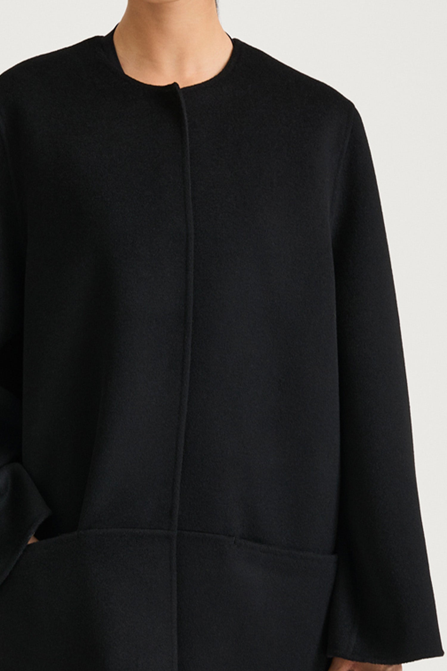 Black wool coat stylein tara front close up model image