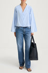 Light blue v-neck shirt stylein jaylene front model image