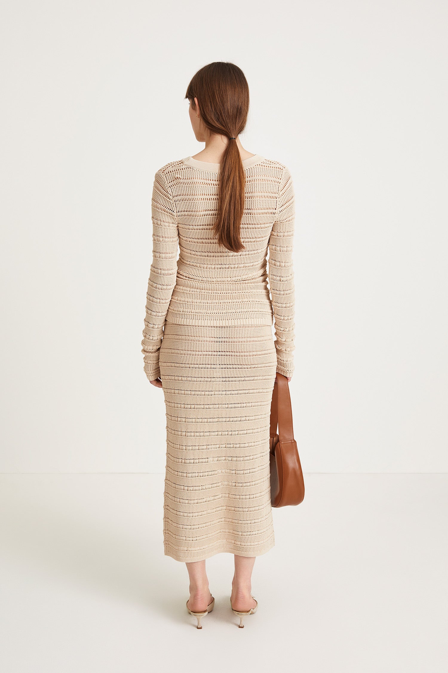 Peach top delicate knitted see-through top fitting silhouette full length sleeves cream stylein back image